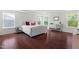 Spacious main bedroom with hardwood floors, ample natural light, and mirrored dresser at 1321 White Spruce Dr, Willow Springs, NC 27592