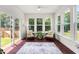 Cozy sunroom with lots of natural light, neutral furniture, and access to the outdoors at 1321 White Spruce Dr, Willow Springs, NC 27592