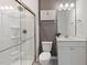 Modern bathroom with glass-enclosed shower, white vanity with quartz countertops, and minimalist decor at 1472 Hasse Ave, Apex, NC 27502