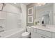 Clean bathroom with a combined tub and shower, white vanity, and neutral wall decor at 1472 Hasse Ave, Apex, NC 27502
