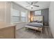 Serene bedroom with a gray accent wall, plush bedding, and plenty of natural light from large windows at 1472 Hasse Ave, Apex, NC 27502