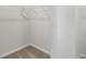 An empty walk-in closet with neutral carpeting and wire shelving at 1472 Hasse Ave, Apex, NC 27502