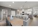 Open-concept kitchen and dining area with stainless steel appliances and center island at 1472 Hasse Ave, Apex, NC 27502
