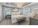 Serene main bedroom featuring a tray ceiling, soft lighting, and tasteful decor at 1472 Hasse Ave, Apex, NC 27502