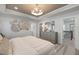 Spacious main bedroom with tray ceiling, dresser, and natural light from windows at 1472 Hasse Ave, Apex, NC 27502