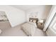 Bright bedroom with tan carpet, queen bed, nightstand, and neutral walls at 154 Beacon Dr, Pittsboro, NC 27312