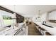 Open-concept dining area with modern table, chairs, stylish lighting, and seamless flow to living spaces at 154 Beacon Dr, Pittsboro, NC 27312