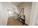 Inviting entryway with wood floors, decor console table, stairs, and natural light from the door at 154 Beacon Dr, Pittsboro, NC 27312