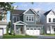 Charming two-story home with blue siding, white trim, an attached garage, and lovely landscaping at 154 Beacon Dr, Pittsboro, NC 27312