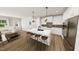Modern kitchen with white cabinets, stainless steel appliances, an island, and an open floor plan at 154 Beacon Dr, Pittsboro, NC 27312