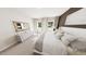 Comfortable main bedroom with lots of natural light, neutral decor, carpet, and a dresser with mirror at 154 Beacon Dr, Pittsboro, NC 27312