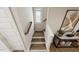 Bright stairway with hardwood steps, white risers, window, and decorative console table at 154 Beacon Dr, Pittsboro, NC 27312