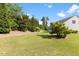 Expansive backyard with lush greenery and a well-maintained lawn at 1705 Bodwin Ln, Apex, NC 27502