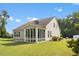 Home's backyard featuring the sunroom and a grassy lawn at 1705 Bodwin Ln, Apex, NC 27502