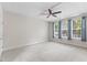 Large bedroom with tray ceilings, fan, and ample natural light at 1705 Bodwin Ln, Apex, NC 27502