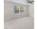 Bright bedroom features a neutral color palette, a ceiling fan, and natural light at 1705 Bodwin Ln, Apex, NC 27502