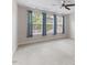 Bedroom with tray ceiling, carpeted floors, and large windows at 1705 Bodwin Ln, Apex, NC 27502