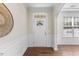 Bright foyer featuring hardwood floors, decorative wainscoting, and an arched doorway at 1705 Bodwin Ln, Apex, NC 27502