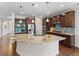 Open kitchen with a large island, granite countertops, stainless steel appliances, and wooden cabinetry at 1705 Bodwin Ln, Apex, NC 27502