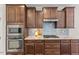 Beautiful kitchen with stainless steel appliances, granite countertops, tile backsplash, and wooden cabinets at 1705 Bodwin Ln, Apex, NC 27502
