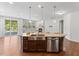Open kitchen with stainless appliances, center island, and hardwood floors at 1705 Bodwin Ln, Apex, NC 27502