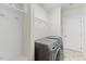 Modern laundry room with shelving and new washer and dryer units at 1705 Bodwin Ln, Apex, NC 27502