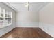 Inviting living room showcasing hardwood floors, elegant wainscoting, and a decorative ceiling at 1705 Bodwin Ln, Apex, NC 27502