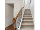 Carpeted staircase with wood railing and wrought iron spindles at 1705 Bodwin Ln, Apex, NC 27502