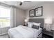 Comfortable bedroom with neutral decor, a large window, and a soft, inviting bed at 181 Churchill Way, Clayton, NC 27520