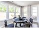 Bright game room featuring a round poker table, comfortable chairs, and views of the backyard at 181 Churchill Way, Clayton, NC 27520