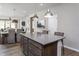 Bright, open kitchen with an island and bar stools, flowing into a dining area and living space at 181 Churchill Way, Clayton, NC 27520