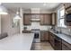 Gourmet kitchen featuring stainless steel appliances, light countertops and dark wood cabinetry at 181 Churchill Way, Clayton, NC 27520