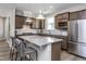 Spacious kitchen featuring a center island with seating, stainless steel appliances, and ample counter space at 181 Churchill Way, Clayton, NC 27520