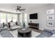 Modern living room with natural light and a sleek ceiling fan, perfect for relaxation and entertainment at 181 Churchill Way, Clayton, NC 27520