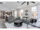 Inviting living room featuring comfortable sofas and an open view to the kitchen and dining areas at 181 Churchill Way, Clayton, NC 27520