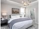Comfortable main bedroom suite featuring neutral decor, large windows, and an adjoining bathroom at 181 Churchill Way, Clayton, NC 27520