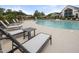 Community pool with lounge chairs, tables, and clubhouse in the background on a sunny day at 181 Churchill Way, Clayton, NC 27520
