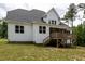 Backyard with a wooden deck accessible by stairs on a two-story home at 190 Whistlers Cv, Louisburg, NC 27549