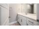 Bright bathroom features a white vanity with quartz countertop and modern fixtures at 190 Whistlers Cv, Louisburg, NC 27549