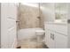 Bright bathroom featuring a shower-tub combo, neutral tile surround, and modern white vanity at 190 Whistlers Cv, Louisburg, NC 27549