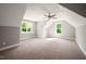 Spacious bedroom with natural light, ceiling fan, and neutral carpeting at 190 Whistlers Cv, Louisburg, NC 27549