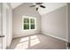 Bright bedroom featuring a carpeted floor, ceiling fan, vaulted ceiling, and lots of natural light at 190 Whistlers Cv, Louisburg, NC 27549