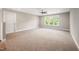 Large bonus room with neutral carpet, natural light from multiple windows, and a ceiling fan at 190 Whistlers Cv, Louisburg, NC 27549