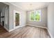 Dining room with wood floors, a modern chandelier, a glass door and a view of the backyard at 190 Whistlers Cv, Louisburg, NC 27549