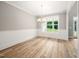 New dining room showcasing wood-look flooring, wainscoting, chandelier, and a picture window at 190 Whistlers Cv, Louisburg, NC 27549