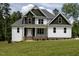 Charming two-story home with white siding, dark trim, and inviting front porch at 190 Whistlers Cv, Louisburg, NC 27549