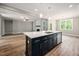 Open kitchen featuring an island with a stainless steel dishwasher and sink with white countertop at 190 Whistlers Cv, Louisburg, NC 27549