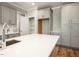 Kitchen featuring gray cabinets, stainless steel appliances, and an island with white countertop at 190 Whistlers Cv, Louisburg, NC 27549