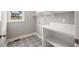 New laundry room with patterned flooring, window, white shelving and countertop at 190 Whistlers Cv, Louisburg, NC 27549