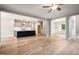 Open concept living, dining and kitchen with wood floors and white walls and trim at 190 Whistlers Cv, Louisburg, NC 27549